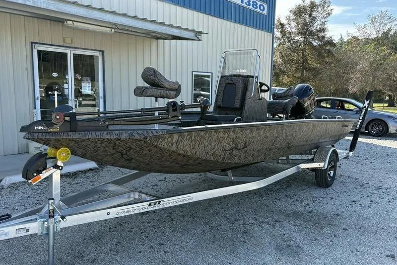 Slide: The Image of 2026 Xpress H20B Bay boat on trailer outside a building, ready for adventure. - 4