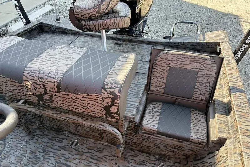 Slide: The Image of 2026 Xpress H20B Bay boat interior with camo-patterned seating and modern design. - 7
