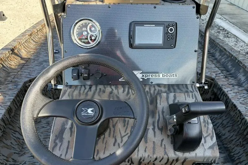 Slide: The Image of 2026 Xpress H20B Bay boat dashboard with steering wheel and control panel. - 8