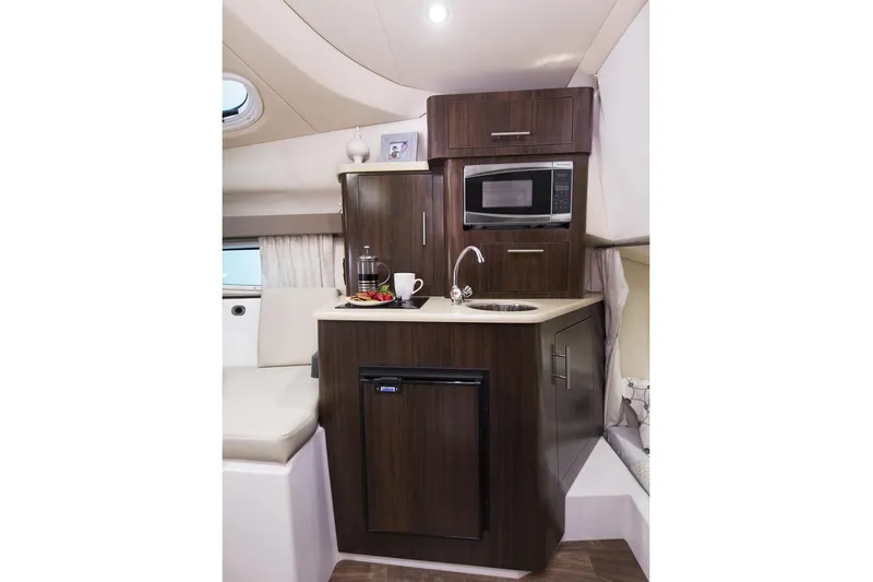 Slide: The Image of Manufacturer Provided Image: 2018 Regal 28 Express boat interior kitchen with microwave, sink, and mini-fridge. - 14