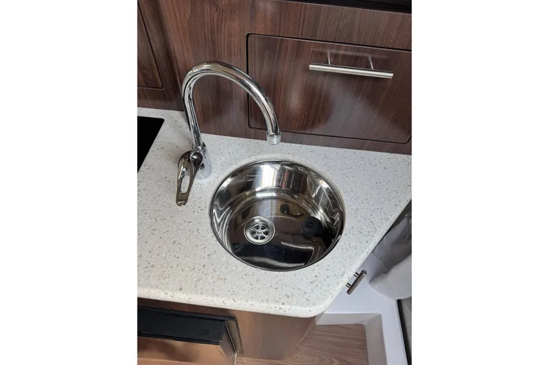 Slide: The Image of Stainless steel sink and faucet in 2018 Regal 28 Express boat interior. - 15