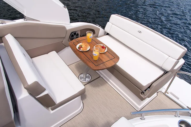 Slide: The Image of Manufacturer Provided Image: 2018 Regal 28 Express boat interior with dining setup on water. - 28