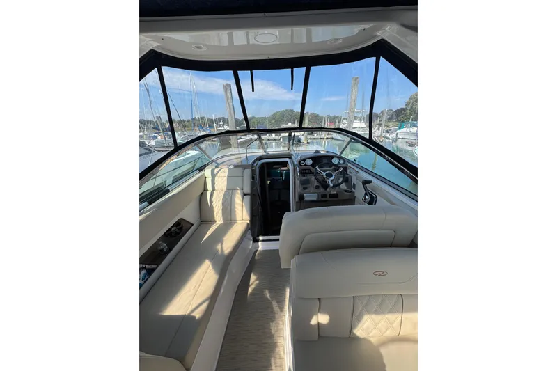 Slide: The Image of Interior view of 2018 Regal 28 Express boat with beige seating and dashboard. - 3