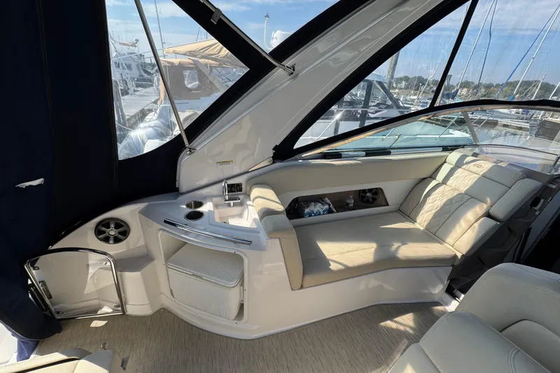 Slide: The Image of 2018 Regal 28 Express boat interior with beige seating and modern amenities. - 4