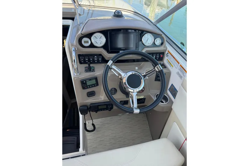 Slide: The Image of Cockpit of 2018 Regal 28 Express boat with steering wheel and control panel. - 5