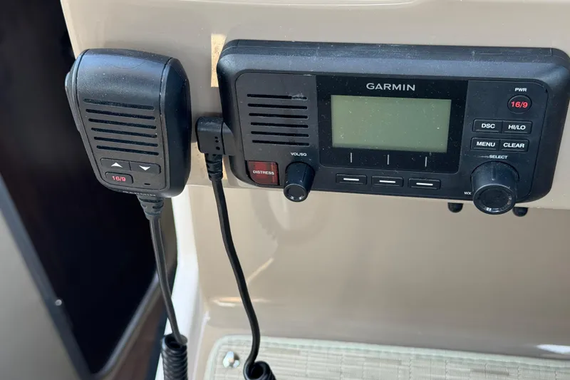 Slide: The Image of Garmin marine radio system on 2018 Regal 28 Express boat dashboard. - 9