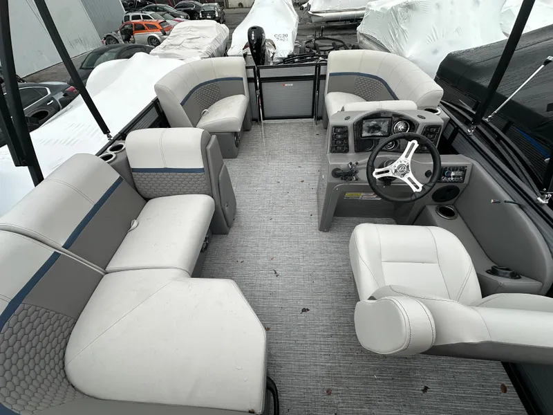 Slide: The Image of 2023 Qwest 816 Lanai LT pontoon boat interior with plush seating and modern dashboard. - 8