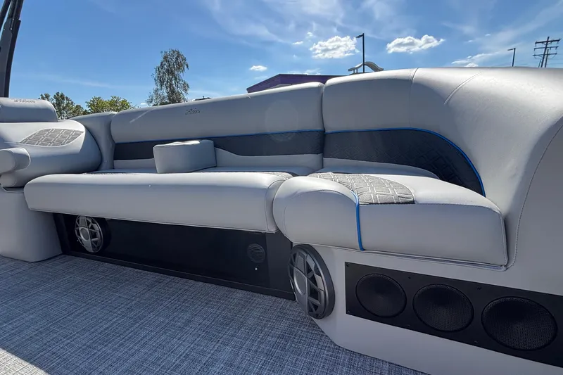 Slide: The Image of Luxurious seating on 2026 JC Neptoon 25TT Sport pontoon boat under clear blue sky. - 14