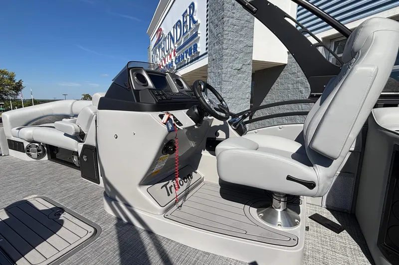 Slide: The Image of 2026 JC Neptoon 25TT Sport boat interior with steering console and seating. - 17