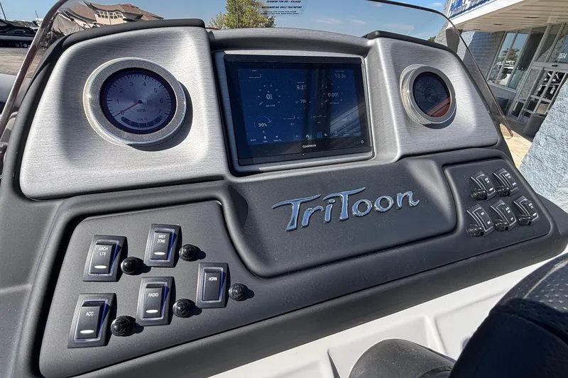 Slide: The Image of 2026 JC Neptoon 25TT Sport dashboard with gauges, switches, and Garmin display. - 18