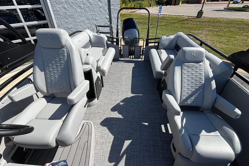Slide: The Image of 2026 JC Neptoon 25TT Sport pontoon boat interior with luxurious gray seating and modern design. - 24