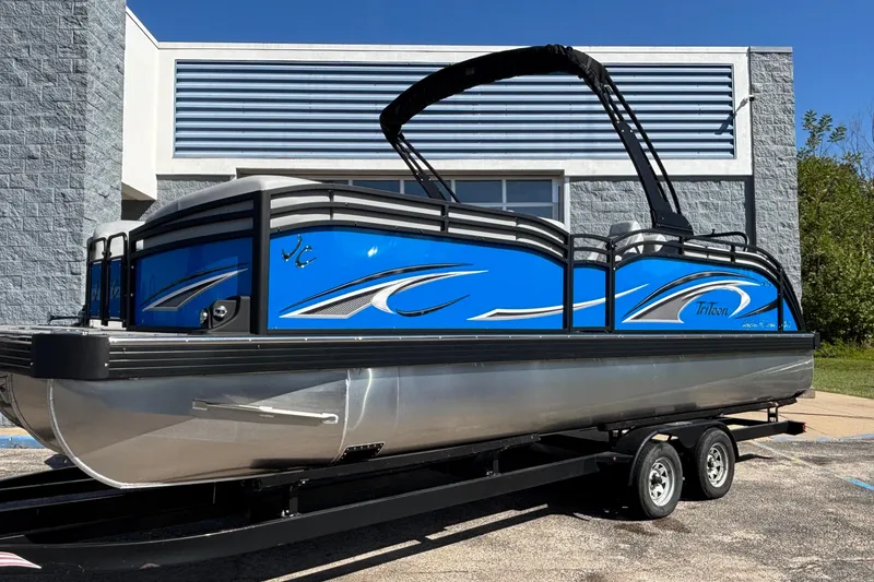 Slide: The Image of 2026 JC Neptoon 25TT Sport pontoon boat with blue accents on a trailer. - 4