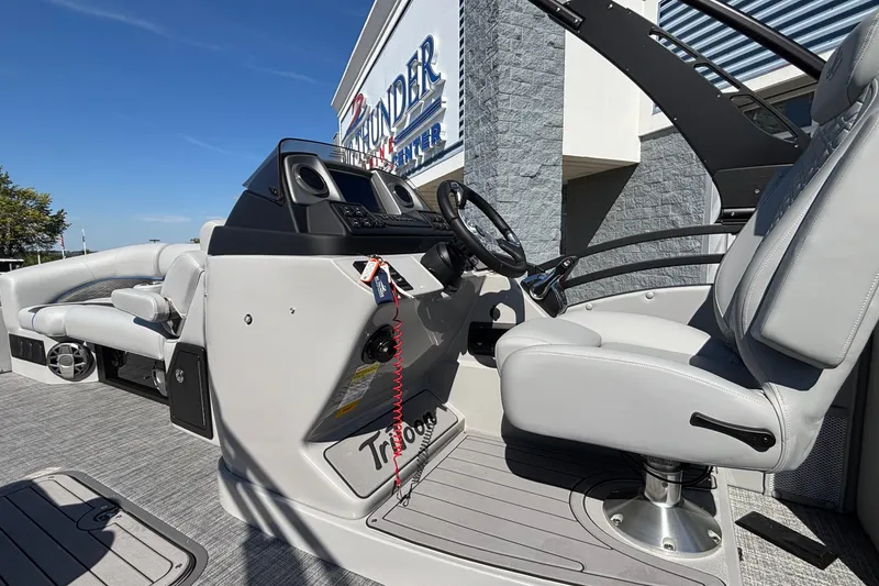 Slide: The Image of 2026 JC Neptoon 25TT Sport boat interior with steering wheel and seating. - 16