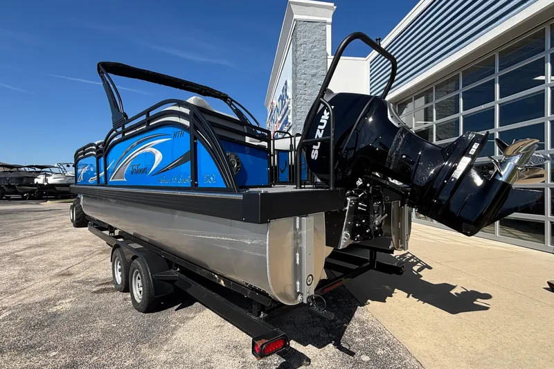 Slide: The Image of 2026 JC Neptoon 25TT Sport pontoon boat with Suzuki outboard motor on trailer. - 2