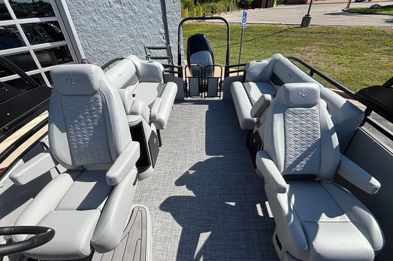 Slide: The Image of 2026 JC Neptoon 25TT Sport pontoon boat with luxurious gray seating and modern design. - 23