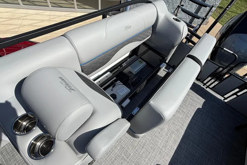 Slide: The Image of Luxury seating on 2026 JC Neptoon 25TT Sport pontoon boat, featuring cup holders and storage. - 32