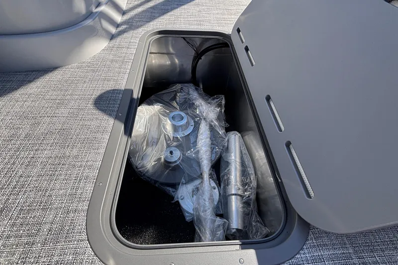Slide: The Image of Open storage compartment on 2026 JC Neptoon 25TT Sport boat with packaged accessories. - 7