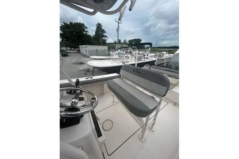 Slide: The Image of 2024 Sea Chaser 24 HFC boat interior with steering wheel and seating. - 4