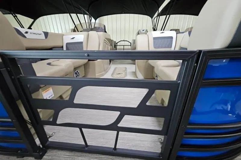 Slide: The Image of Interior view of 2026 Starcraft SLS 3 R pontoon boat with beige seating and black railing. - 13