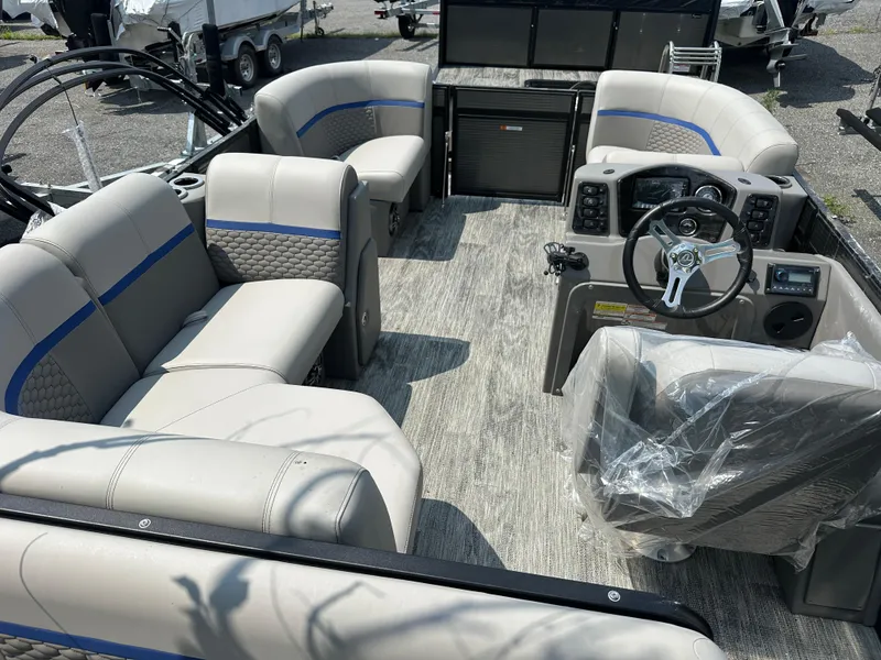 Slide: The Image of 2023 Qwest 816 Lanai LT pontoon boat interior with plush seating and modern dashboard. - 3