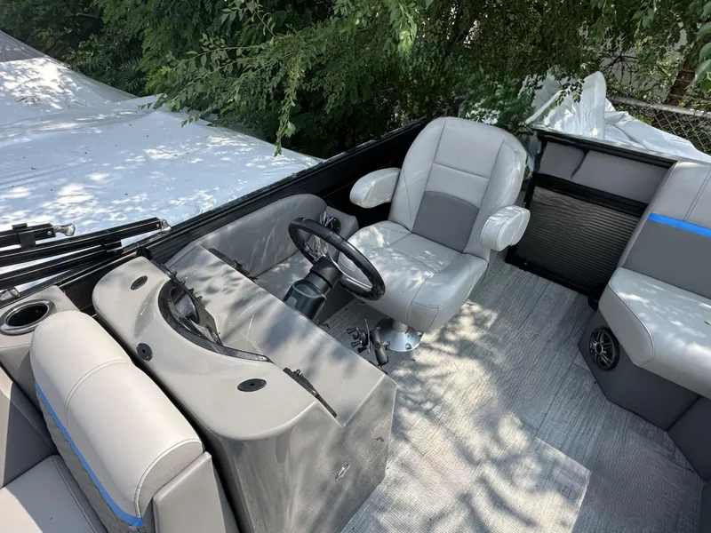 Slide: The Image of 2023 Qwest 816 Lanai LT boat interior with gray seating and steering wheel. - 6