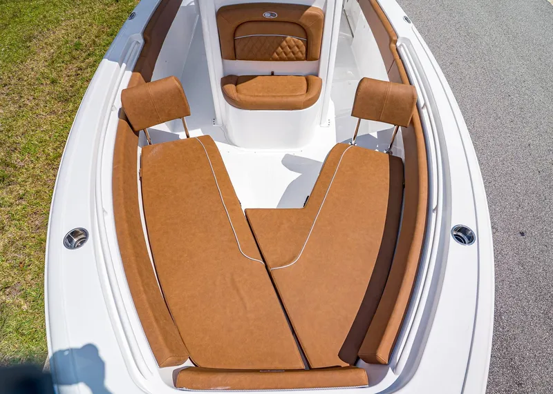 Slide: The Image of 2026 Sea Hunt Ultra 239 boat with brown cushioned seating and white deck. - 20