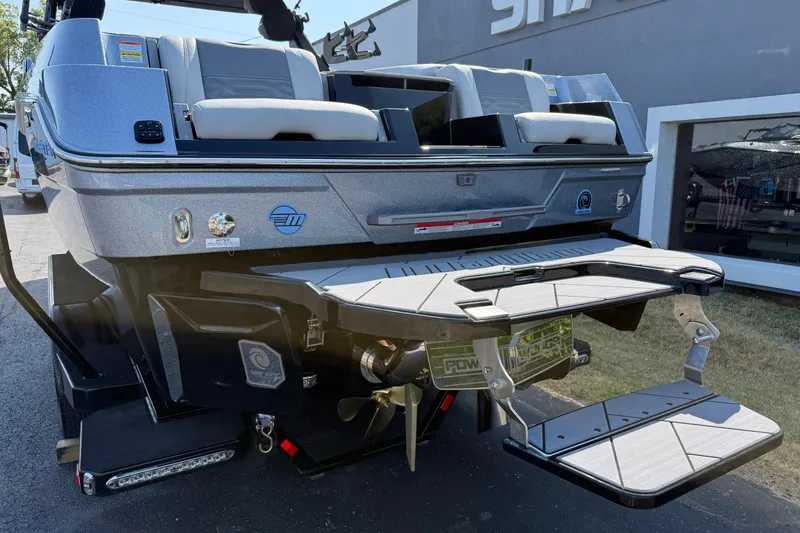 Slide: The Image of 2026 Malibu Wakesetter 26 LSV boat rear view with swim platform and seating. - 10