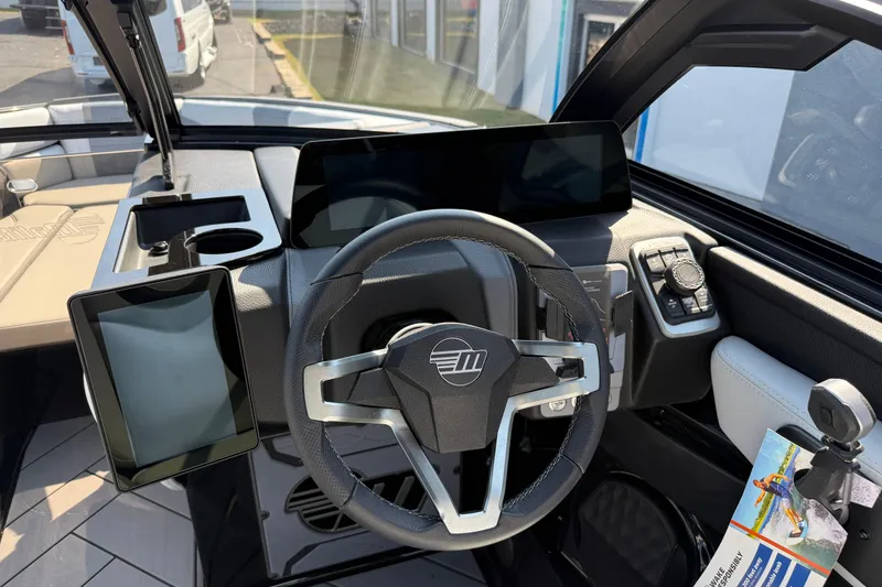Slide: The Image of 2026 Malibu Wakesetter 26 LSV dashboard with modern steering and digital displays. - 17