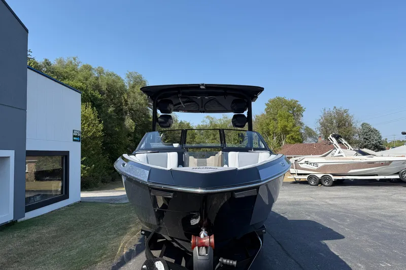 Slide: The Image of 2026 Malibu Wakesetter 26 LSV boat parked outdoors on a sunny day. - 2