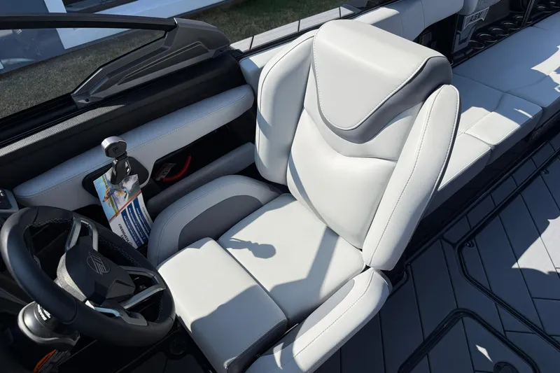 Slide: The Image of 2026 Malibu Wakesetter 26 LSV interior with sleek white seating and modern steering wheel. - 25