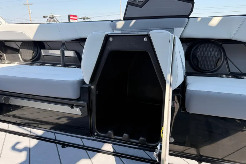 Slide: The Image of 2026 Malibu Wakesetter 26 LSV interior storage compartment with sleek seating design. - 30