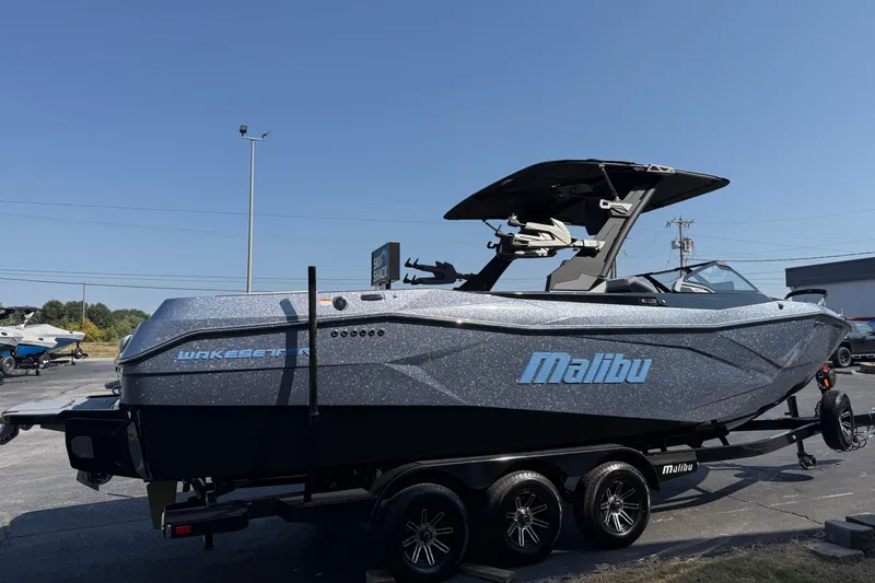 Slide: The Image of 2026 Malibu Wakesetter 26 LSV boat on trailer, sleek design, outdoor display. - 4