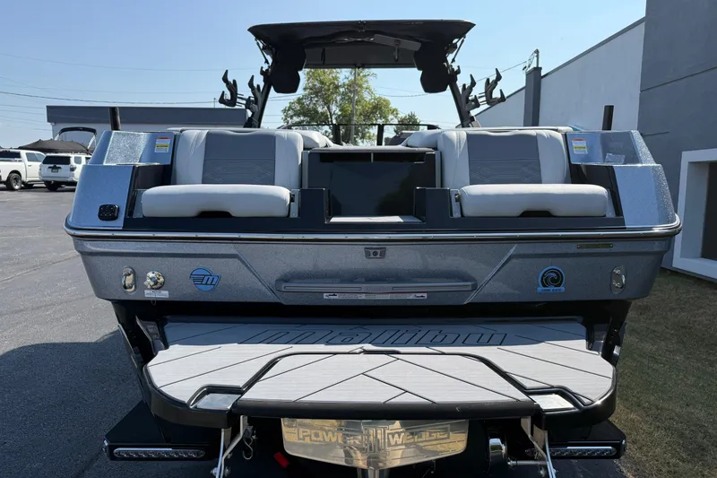 Slide: The Image of 2026 Malibu Wakesetter 26 LSV boat, rear view with seating and swim platform. - 6