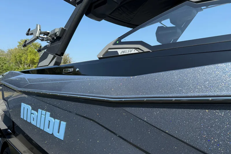 Slide: The Image of 2026 Malibu Wakesetter 26 LSV boat with sleek design and metallic finish. - 7