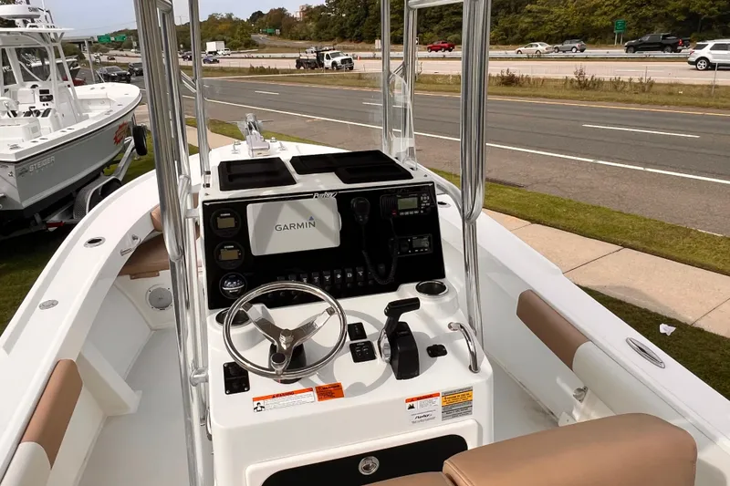 Slide: The Image of 2018 Parker 2100 Special Edition boat with Garmin navigation, parked near a highway. - 6
