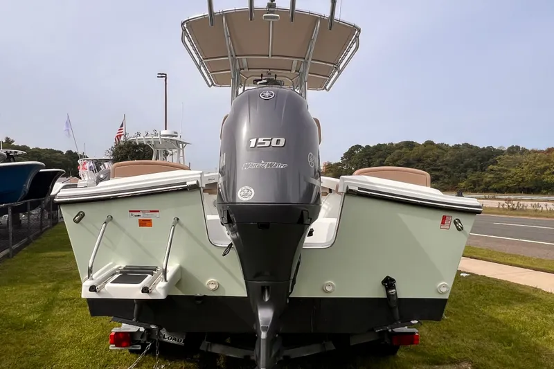Slide: The Image of 2018 Parker 2100 Special Edition boat with Yamaha 150 engine, displayed outdoors. - 7
