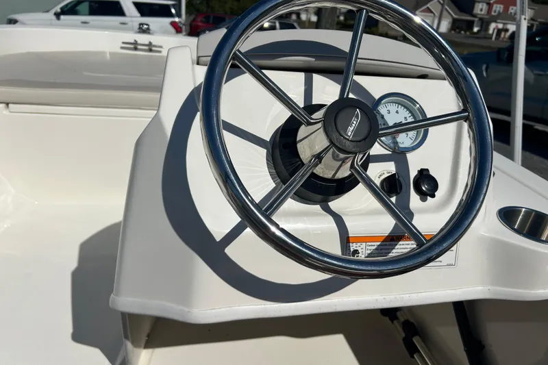 Slide: The Image of 2023 Boston Whaler 130 Super Sport steering wheel and dashboard close-up. - 10