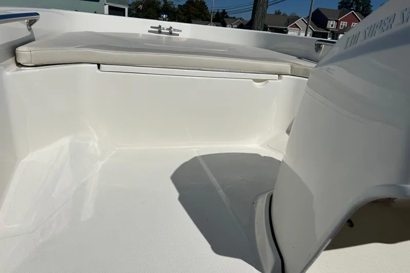 Slide: The Image of 2023 Boston Whaler 130 Super Sport interior with seating and clean white finish. - 14
