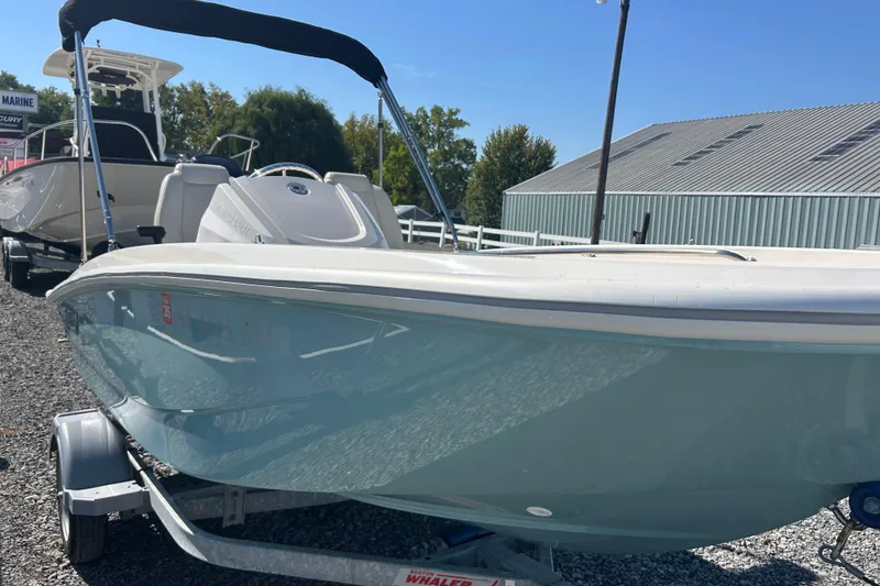 Slide: The Image of 2023 Boston Whaler 130 Super Sport boat on trailer, outdoor display. - 7