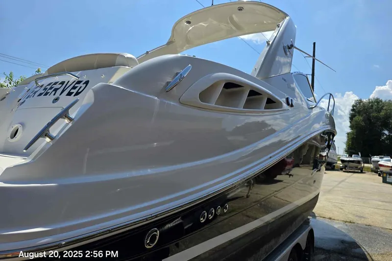 Slide: The Image of 2008 Sea Ray 290 Sundancer boat on trailer under clear blue sky. - 1