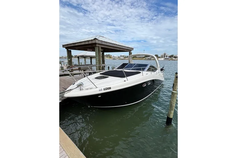 Slide: The Image of 2008 Sea Ray 290 Sundancer docked at marina under blue sky. - 17