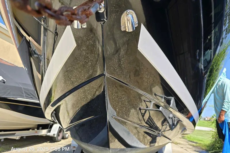 Slide: The Image of Close-up of a 2008 Sea Ray 290 Sundancer boat hull, reflecting surroundings. - 2