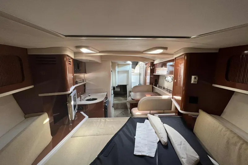 Slide: The Image of 2008 Sea Ray 290 Sundancer cabin interior with kitchenette and seating area. - 6