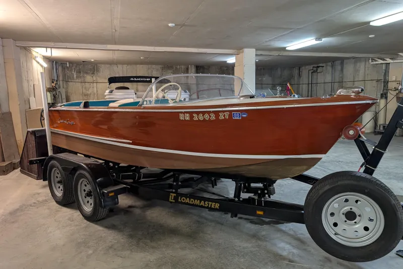Slide: The Image of 1967 Chris-Craft 17 Sportsman boat on trailer in a garage setting. - 1