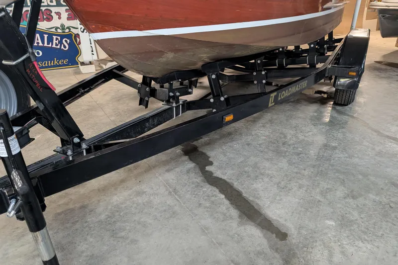 Slide: The Image of 1967 Chris-Craft 17 Sportsman boat on Loadmaster trailer in garage setting. - 11