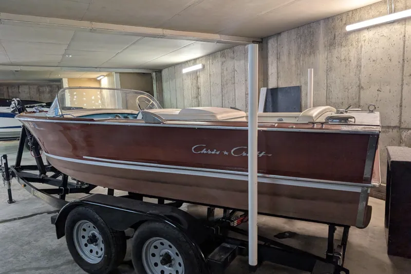 Slide: The Image of 1967 Chris-Craft 17 Sportsman boat on trailer in a garage setting. - 2