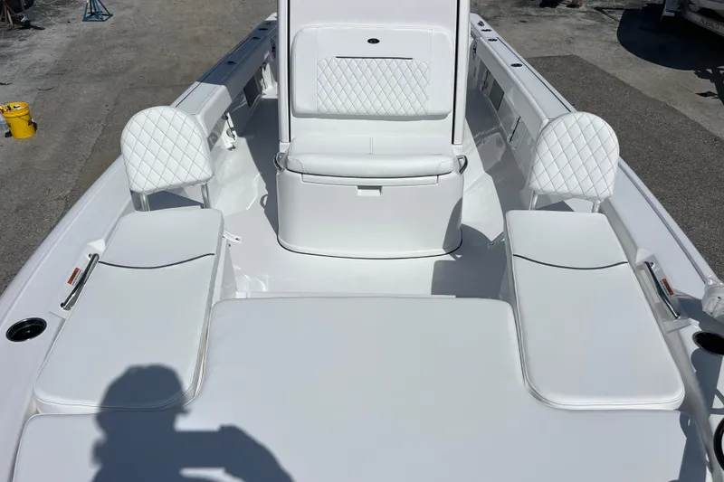 Slide: The Image of 2026 Sportsman Masters 247 Bay Boat interior with white cushioned seating. - 11