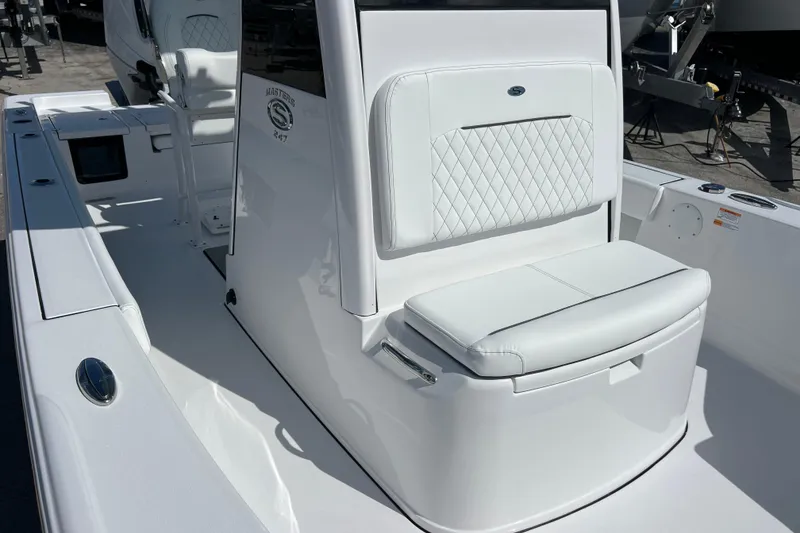 Slide: The Image of 2026 Sportsman Masters 247 Bay Boat with white cushioned seating and sleek design. - 13