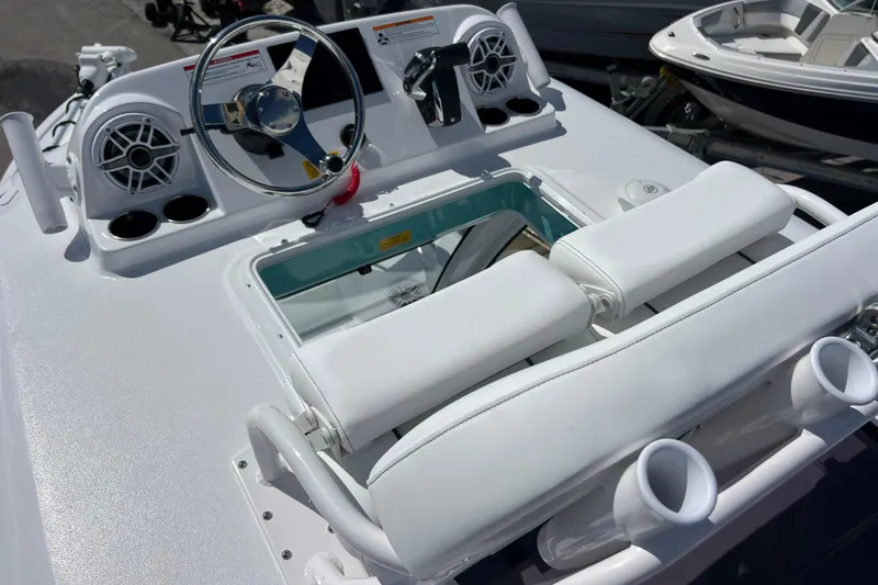 Slide: The Image of 2026 Sportsman Masters 247 Bay Boat helm with steering wheel and seating. - 18