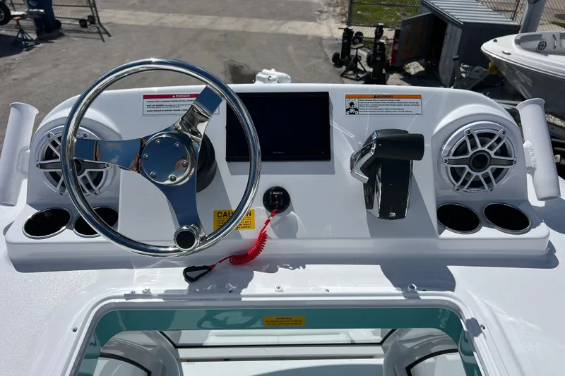 Slide: The Image of 2026 Sportsman Masters 247 Bay Boat dashboard with steering wheel and controls. - 19